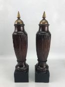 Pair of carved ornamental finials with brass detailing to top, approx 45cm tall