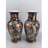 Pair of Chinese vases with red and blue colourway depicting Chinese figures, orange stamps to