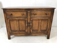 Ercol sideboard with two drawers and cupboards under. Ercol blue label to inner door