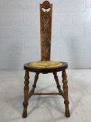 Carved narrow-backed chair with removable back rest and upholstered seat