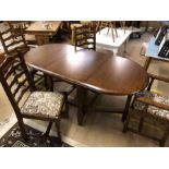Drop leaf dining table with four ladder back chairs with upholstered seats, including two carvers,
