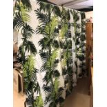 Pair of lined curtains with green fern design on white background. Each curtain approx 157cm wide