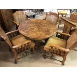 Circular extending dining table on pedestal base with four turned legs, along with four carver