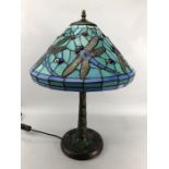 Tiffany style table lamp with leaded glass shade. Dragonfly detail to shade and base. Approx. 58cm