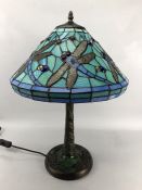 Tiffany style table lamp with leaded glass shade. Dragonfly detail to shade and base. Approx. 58cm