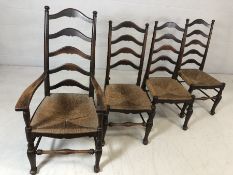 Four rush-seated ladder back chairs to include one carver