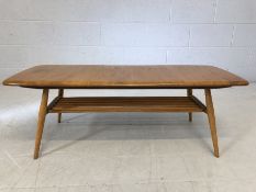 Ercol low coffee table on tapered legs with slatted shelf approx 105cms x 43cm x 35 cms tall