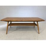 Ercol low coffee table on tapered legs with slatted shelf approx 105cms x 43cm x 35 cms tall