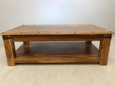 Large mexican style coffee table with metal detailing and shelf under. Approx 134cms x 76cms x 45cms