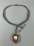 Hallmarked Silver watch chain with hallmarked Albert and a Silver medallion in the shape of a shield