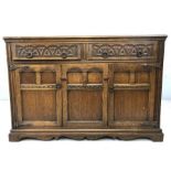 Sideboard with carved design to drawers and panelling to doors - two drawers and two cupboards