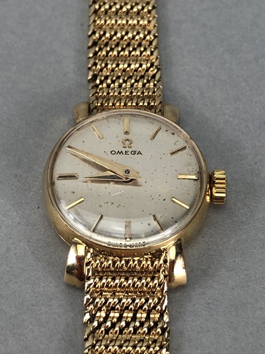 Ladies 9ct Gold OMEGA wristwatch with silver coloured dial and 9ct 375 strap (total weight 23.4g)