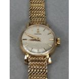 Ladies 9ct Gold OMEGA wristwatch with silver coloured dial and 9ct 375 strap (total weight 23.4g)