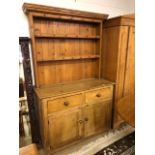 Large Pine dresser of two cupboards, two drawers and shelves over