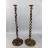 Two large brass twisted stem candlesticks with flared candle holders with circular bases