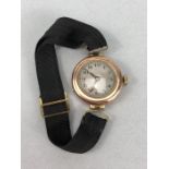 9ct Rose Gold ladies watch with Roman numerals and a fabric strap (total weight 14g)