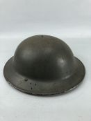 Military tin Brodie helmet with original webbing and black liner