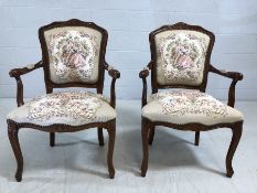 Pair of reproduction upholstered carver chairs with floral design