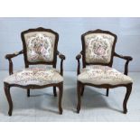 Pair of reproduction upholstered carver chairs with floral design