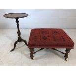 Carved wood footstall on castors with red upholstered top, along with a single occasional pedestal