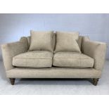 John Lewis two-seater cream upholstered sofa, approx 150cm x 100cm x 83cm tall at back