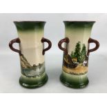 Pair of Longpark cylindrical vases with loop handles, one with 'Cockington Forge Torquay' design,