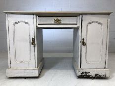 Knee hole desk on four castors with pale grey paint effect. With two cupboards and drawer under,