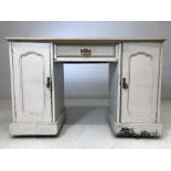 Knee hole desk on four castors with pale grey paint effect. With two cupboards and drawer under,