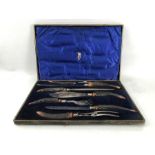 EDWARDIAN DOUBLE CARVING SET with a sharpening steel, all with antler handles and marked '