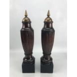Pair of carved ornamental finials with brass detailing to top, approx 45cm tall