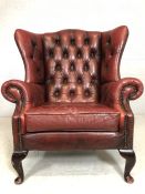 Vintage red leather wingback armchair (A/F)