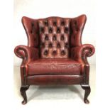 Vintage red leather wingback armchair (A/F)