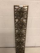 Ornamental cast polished steel grate or decorative fireplace piece depicting flowers, approx 20cm