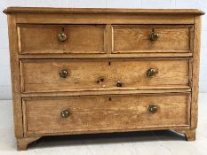 Low antique pine chest of four drawers with brass handles. Approx 104cms x 51cms x 72cms tall