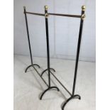 Pair of black and gold garment / clothes hanging rails, each approx 103cm in length and 163cm tall