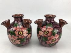 Pair of Longpark five neck udder vases, on purple ground with floral decoration, incised 39, each