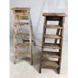 Two sets of vintage wooden step ladders, the tallest approx 130cm in height