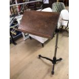 Adjustable iron-based bed table on castors, approx 66cm wide