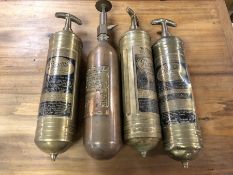 Four vintage brass and copper fire extinguishers