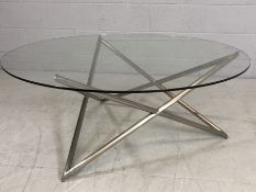 Modern glass-topped coffee table with aluminium 'star' shaped frame, approx 110cm in diameter