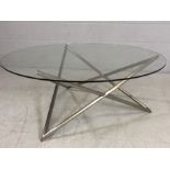 Modern glass-topped coffee table with aluminium 'star' shaped frame, approx 110cm in diameter