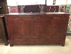 Large oriental-style sideboard with red and gold paint effect, with three drawers and cupboard,