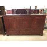 Large oriental-style sideboard with red and gold paint effect, with three drawers and cupboard,