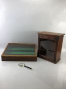 Two display cases and a magnifying glass