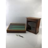 Two display cases and a magnifying glass