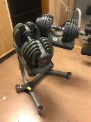 Set of Bowflex dial up weight dumbbells on stand
