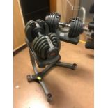 Set of Bowflex dial up weight dumbbells on stand