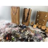 Large collection of new costume jewellery along with homemade wooden display stands (ideal for