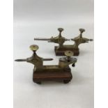 Brass Precision instruments/ gauges on mahogany stands approx. 9cm tall