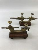 Brass Precision instruments/ gauges on mahogany stands approx. 9cm tall
